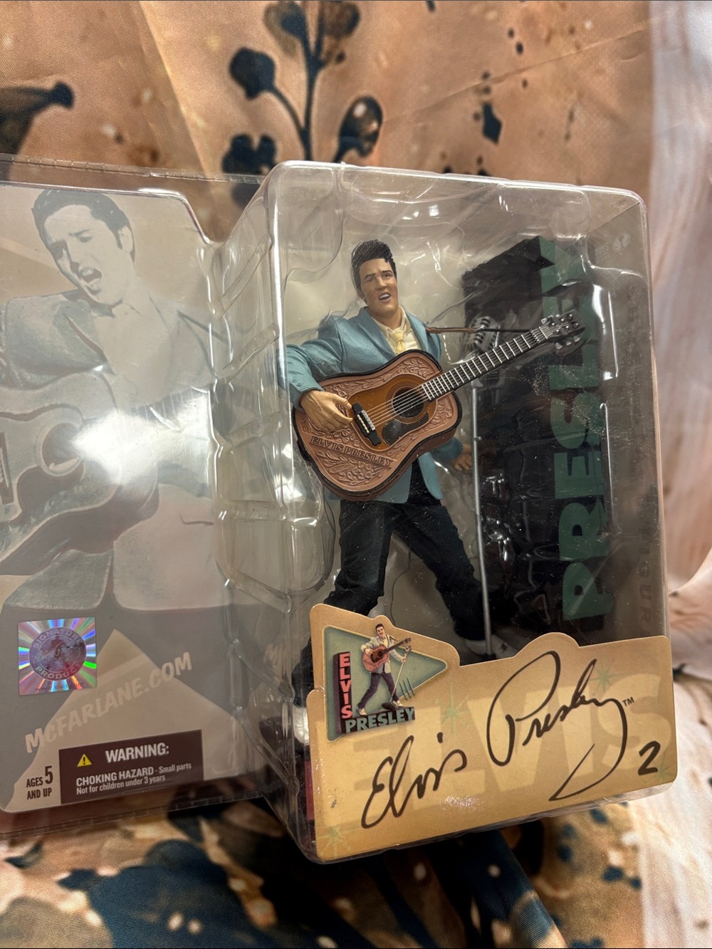 Collectible Figure with Blue Jacket and Brown Guitar
